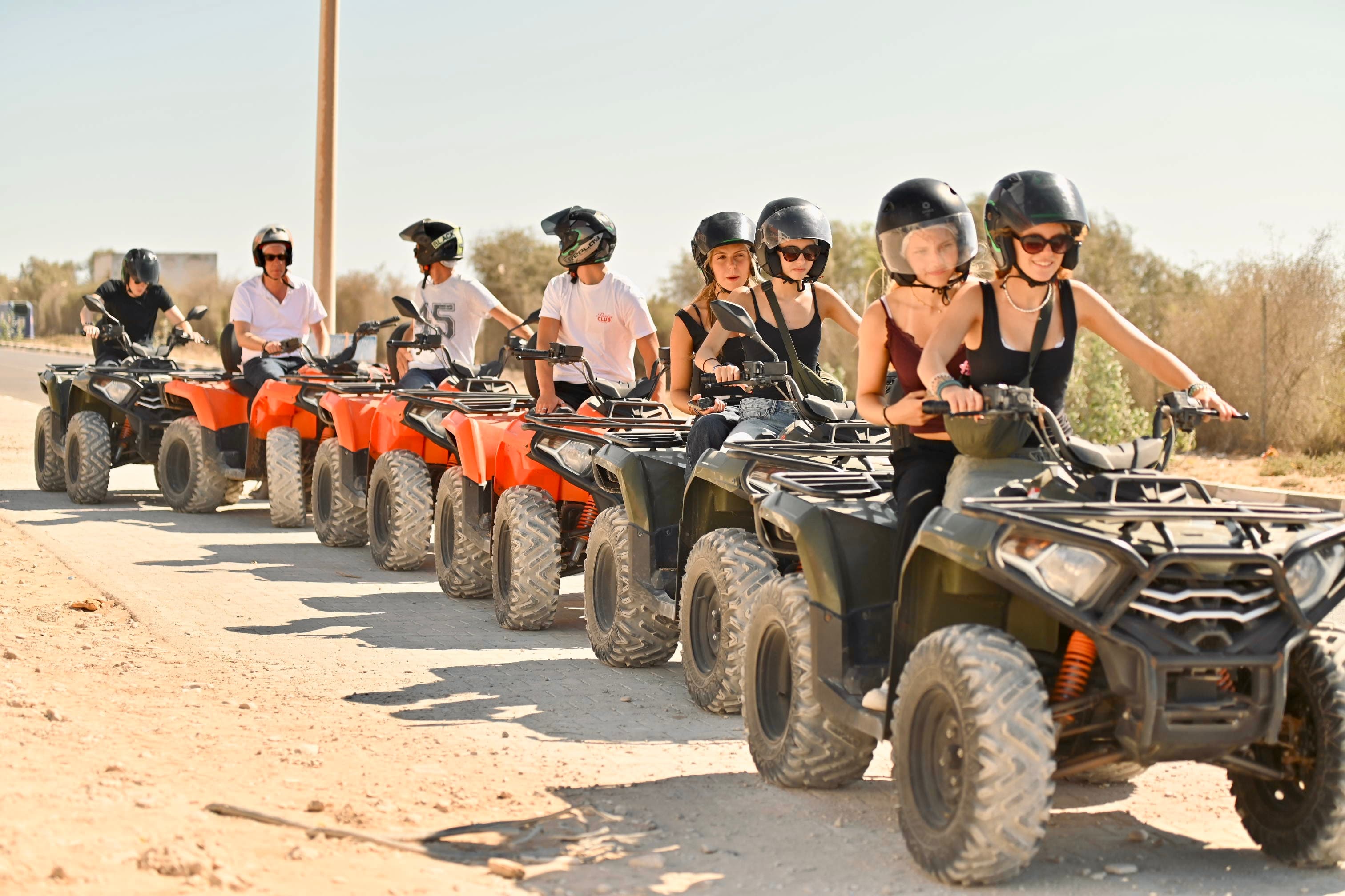 Smiling group lined up on quads ready for the adventure