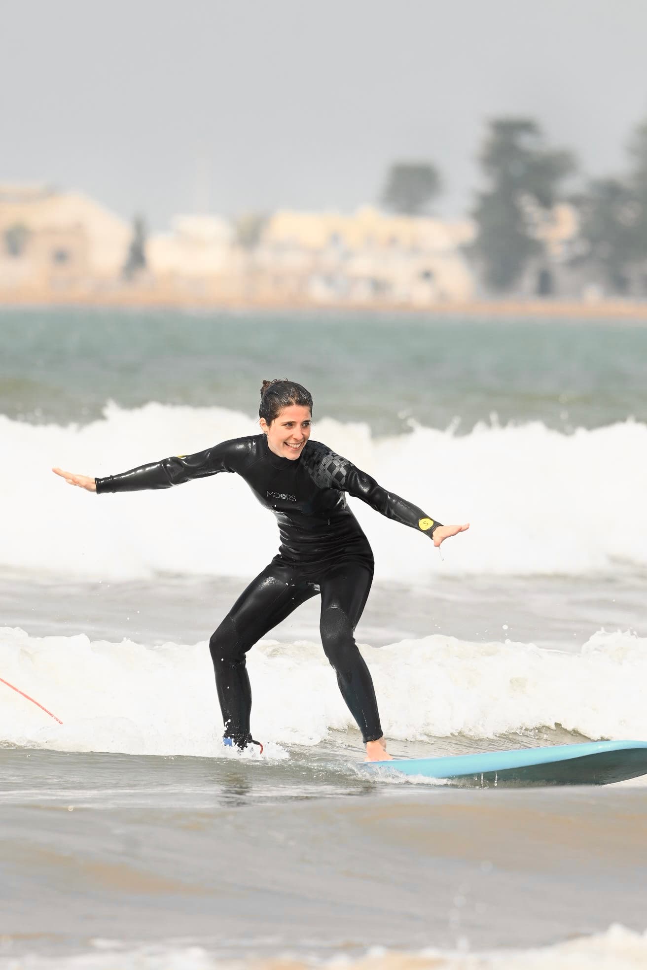 Surf student standing up on a wave during a lesson in Essaouira